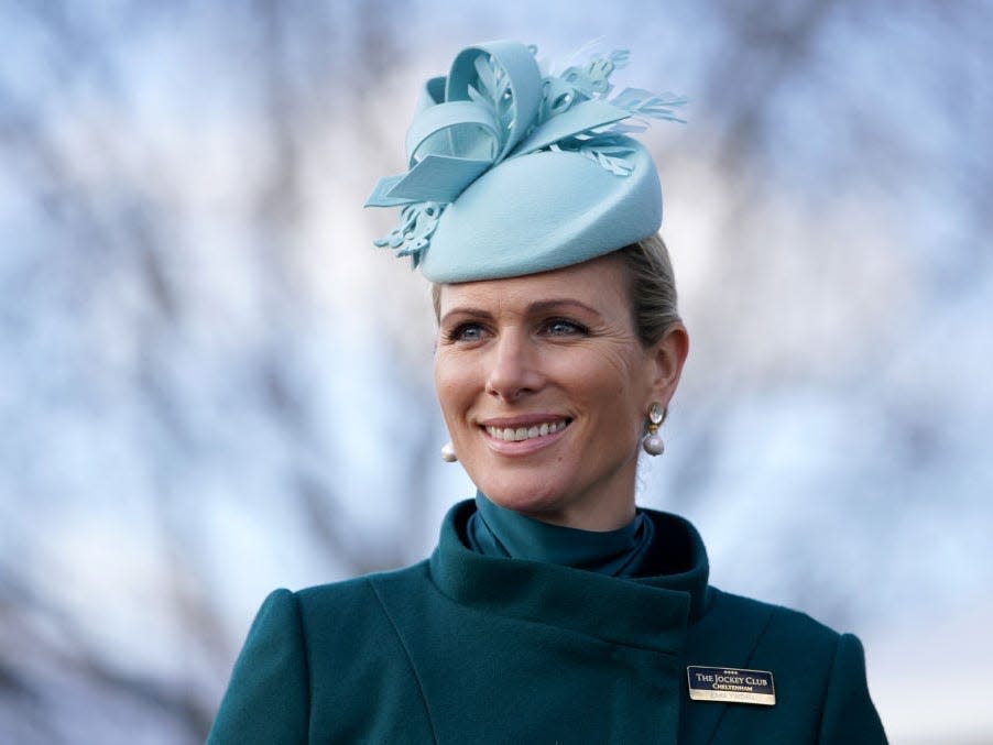 Zara Tindall wearing a turquoise coat and light blue hat