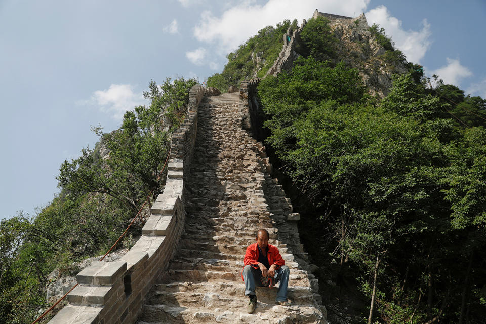 <p>A man rests while working on the reconstruction of the Jiankou section of the Great Wall, located in Huairou District, north of Beijing, China, June 7, 2017. (Photo: Damir Sagolj/Reuters) </p>