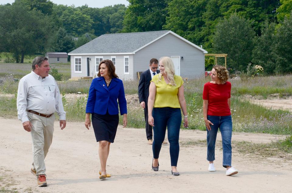 (From left) State Sen. John Damoose, Gov. Gretchen Whitmer, Northwest Michigan Habitat for Humanity Executive Director Sarah Ulrich, and Michigan State Housing Development Authority Executive Director Amy Hovey tour the Meadowlands subdivision project on Tuesday, Aug. 1, 2023.