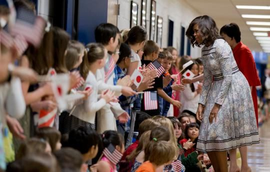 Michelle Obama in a Tadashi Shoji dress visiting a school in Washington, DC. 