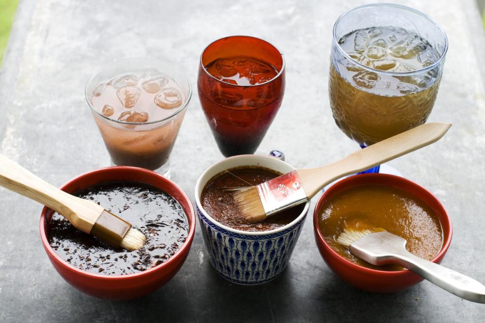 In this image taken on June 10, 2013, from left, balsamic strawberry jalapeno barbecue sauce, recado rojo, and tangy apricot barbecue sauce, are shown with cocktails in Concord, N.H. (AP Photo/Matthew Mead)