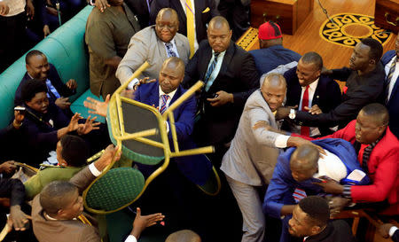 Ugandan lawmakers involve in a fight in the parliament ahead of proposed age limit amendment bill debate a move to change the constitution to extend the president's rule, in Kampala, Uganda September 26, 2017. REUTERS/James Akena