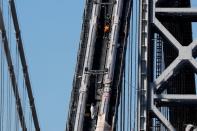 Construction workers on George Washington Bridge duering reconstruction in New York