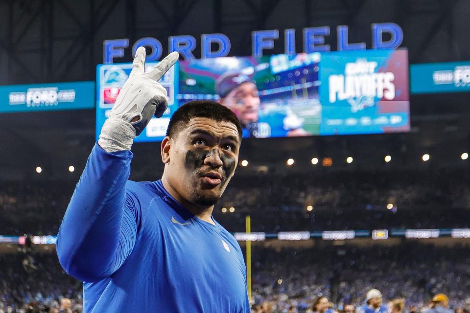 Detroit Lions offensive tackle Penei Sewell signals for two more wins as he celebrates the 31-23 victory over the Tampa Bay Buccaneers in the NFC divisional round playoff game at Ford Field in Detroit on Sunday, Jan. 21, 2024.