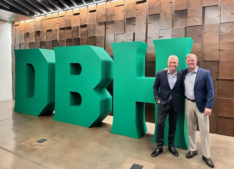 Diamond Baseball Holdings CEO Peter Freund, left, and executive chairman Pat Battle pose for a picture in front of their company logo in Las Vegas at the MLB Fall Meetings in November.