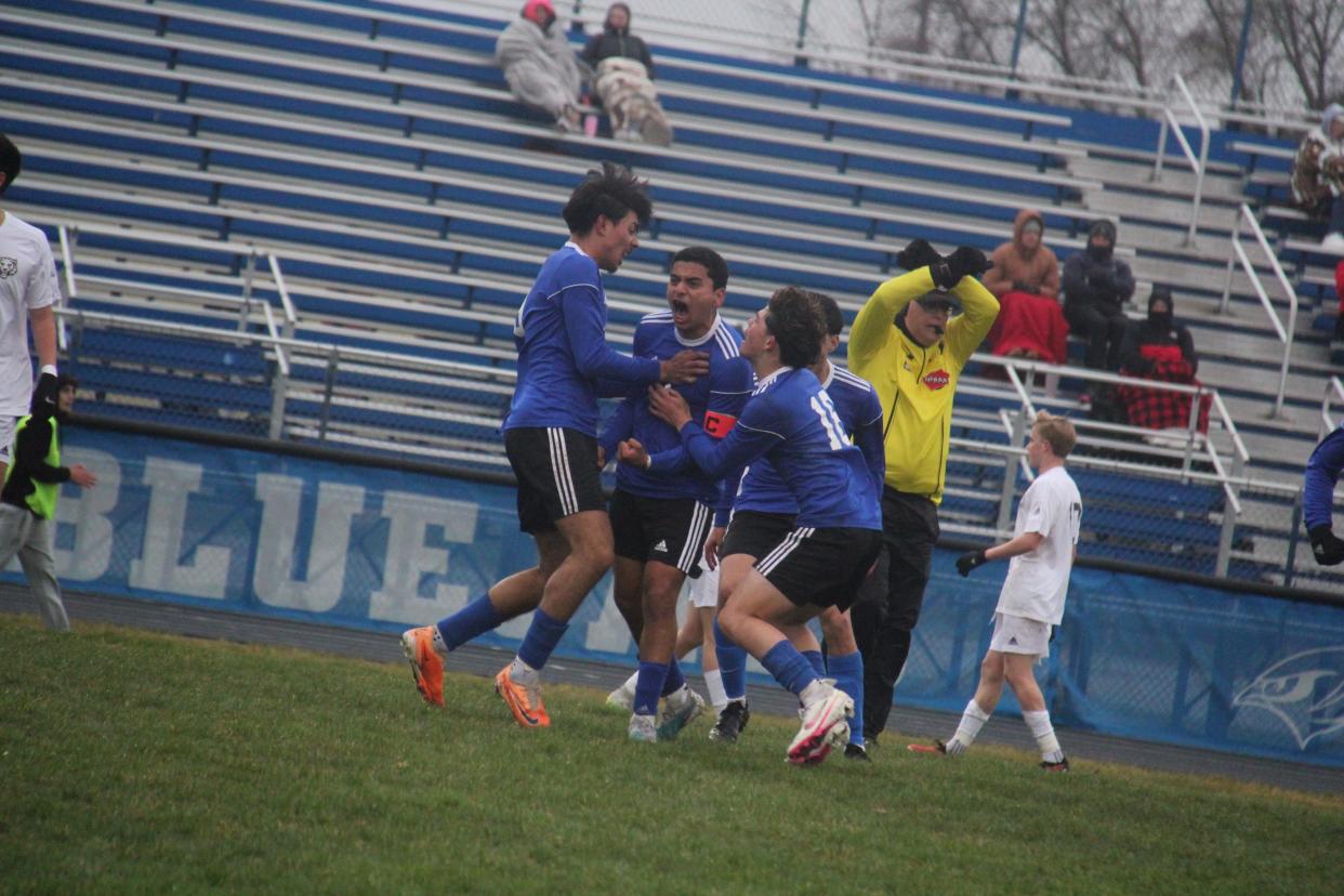 Perry's Jonathan Barrios-Munoz, center, celebrates with teammates after scoring a goal against ADM on Monday, April 1, 2024, at Dewey Field.