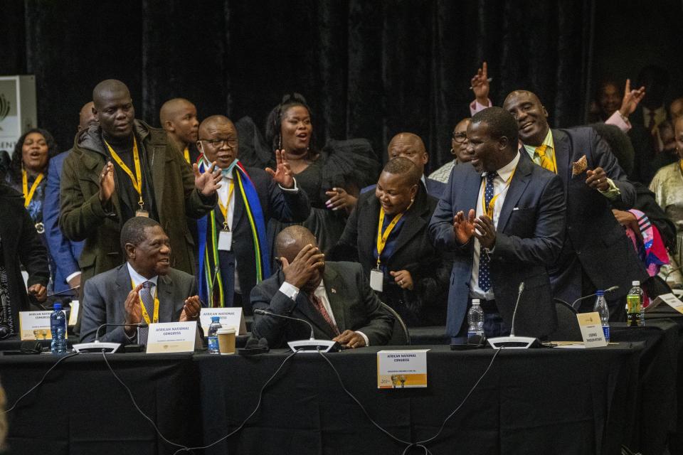 African National Congress lawmakers and South African président Cyril Ramaphosa react after his being reelected as leader of the country in Cape Town, South Africa, Friday, June 14, 2024. (AP Photo/Jerome Delay)