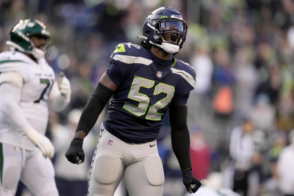 Seattle Seahawks defensive end Darrell Taylor (52) celebrates a defensive stop against the -n- during the second half of an NFL football game, Sunday, Jan. 1, 2023, in Seattle. (AP Photo/Godofredo A. Vásquez)