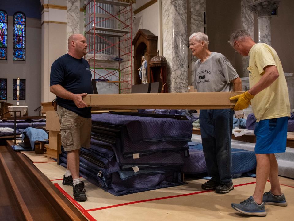 People move pieces of the new organ through St. Benedict Cathedral in Evansville, Ind., Wednesday, July 10, 2024.