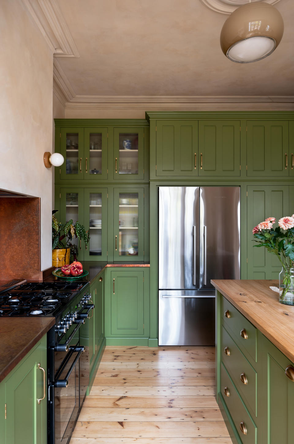 Green kitchen with plaster walls and ceiling