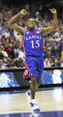 FILE - In this April 7, 2008, file photo, Kansas' Mario Chalmers (15) celebrates after hitting a three point shot to take the game into overtime against Memphis during the championship game at the NCAA college basketball Final Four Monday, April 7, 2008, in San Antonio. (AP Photo/Eric Gay, FIle)