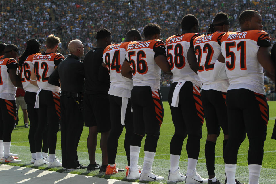 <p>Members of the Cincinnati Bengals stand with arms locked as a sign of unity during the national anthem prior to their game against the Green Bay Packers at Lambeau Field on September 24, 2017 in Green Bay, Wisconsin. (Photo by Dylan Buell/Getty Images) </p>
