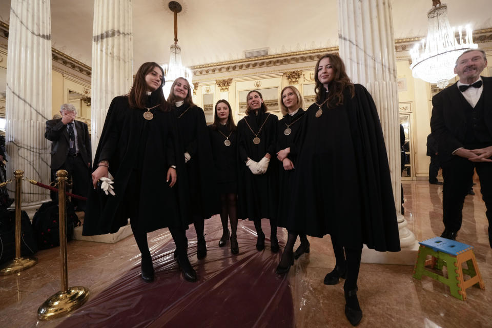 Teather ushers pose for photographers on the occasion of La Scala opera house's gala season opener, Giuseppe Verdi's opera 'Don Carlo' at the Milan La Scala theater, Italy, Thursday Dec. 7, 2023. The season-opener Thursday, held each year on the Milan feast day St. Ambrose, is considered one of the highlights of the European cultural calendar. (AP Photo/Luca Bruno)