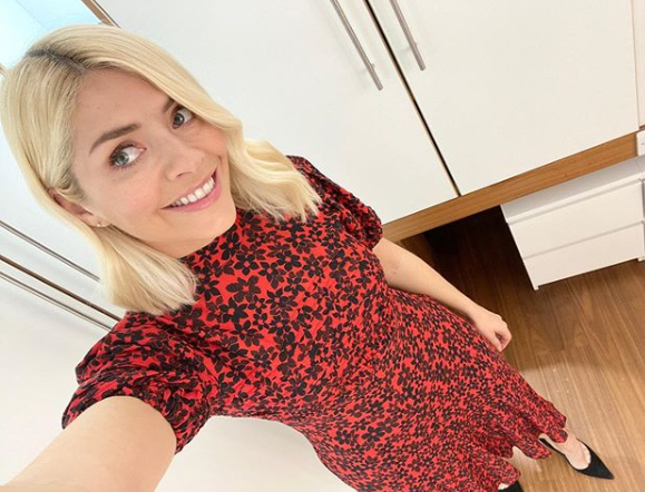 Holly Willoughby is wearing a beautiful red and black floral dress on This Morning: Instagram @ Holly Willoughby