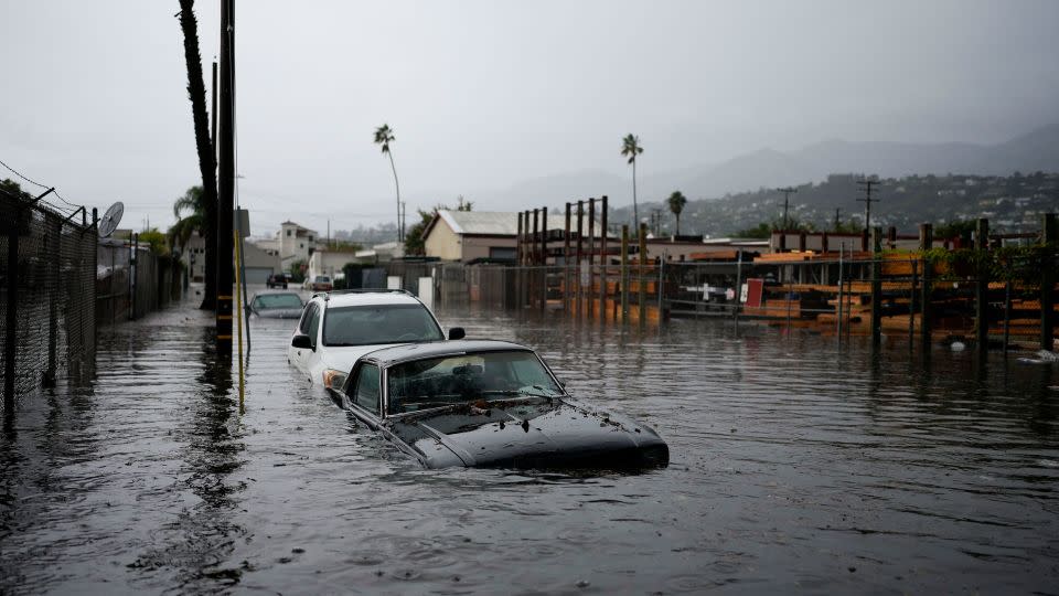 Cars are submerged on a flooded street during a rainstorm in Santa Barbara, California. - Jae C. Hong/AP