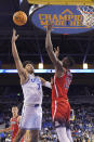 UCLA guard Johnny Juzang, left, shoots as Arizona center Christian Koloko defends during the first half of an NCAA college basketball game Tuesday, Jan. 25, 2022, in Los Angeles. (AP Photo/Mark J. Terrill)