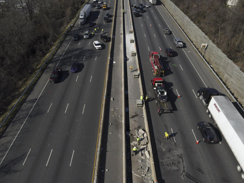 Emergency personnel work at the scene of a fatal crash along Interstate 695 on Wednesday, March 22, 2023, near Woodlawn, Md. Multiple people were killed when a passenger vehicle pulled into a work zone along the Baltimore beltway and struck construction workers there, Maryland State Police said Wednesday. (AP Photo/Julio Cortez)