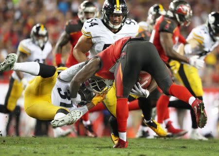 Sep 24, 2018; Tampa, FL, USA; Pittsburgh Steelers defensive back Nat Berhe (31) tackles Tampa Bay Buccaneers running back Shaun Wilson (38) while being flagged on the play during the first half at Raymond James Stadium. Mandatory Credit: Kim Klement-USA TODAY Sports