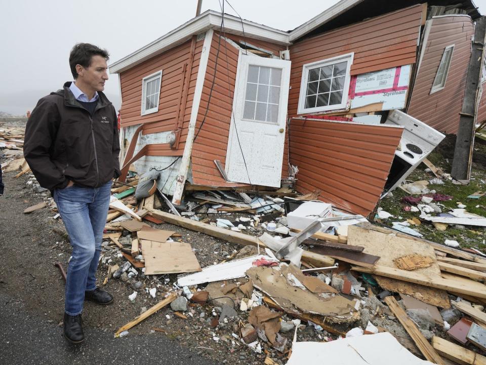 Prime Minister Justin Trudeau tours the damage caused by Fiona in Port aux Basques, N.L. on Sept. 28. THE CANADIAN PRESS/Frank Gunn