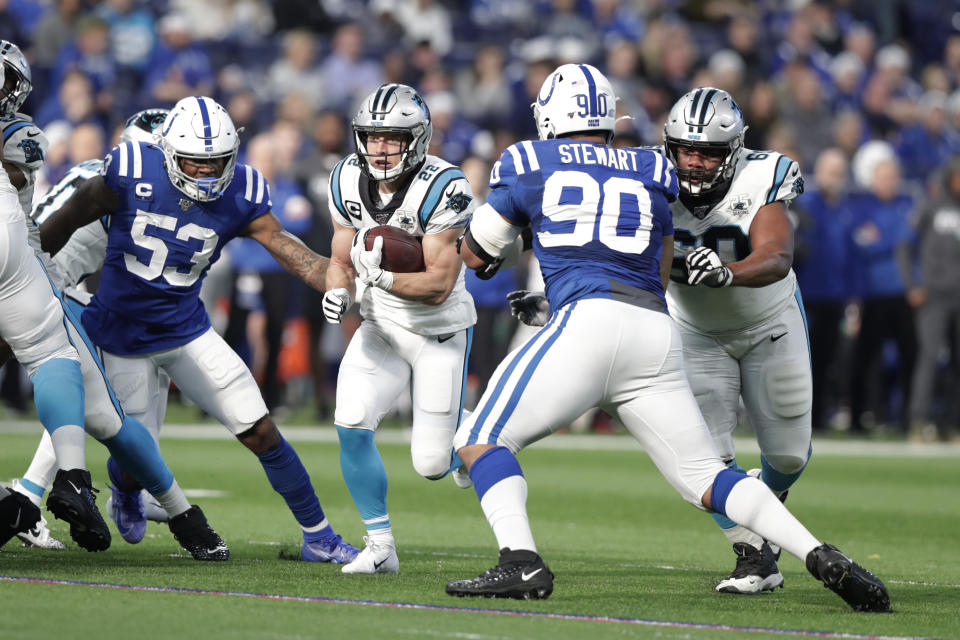 Carolina Panthers' Christian McCaffrey (22) runs against Indianapolis Colts' Darius Leonard (53) and Grover Stewart (90) during the first half of an NFL football game, Sunday, Dec. 22, 2019, in Indianapolis. (AP Photo/Michael Conroy)