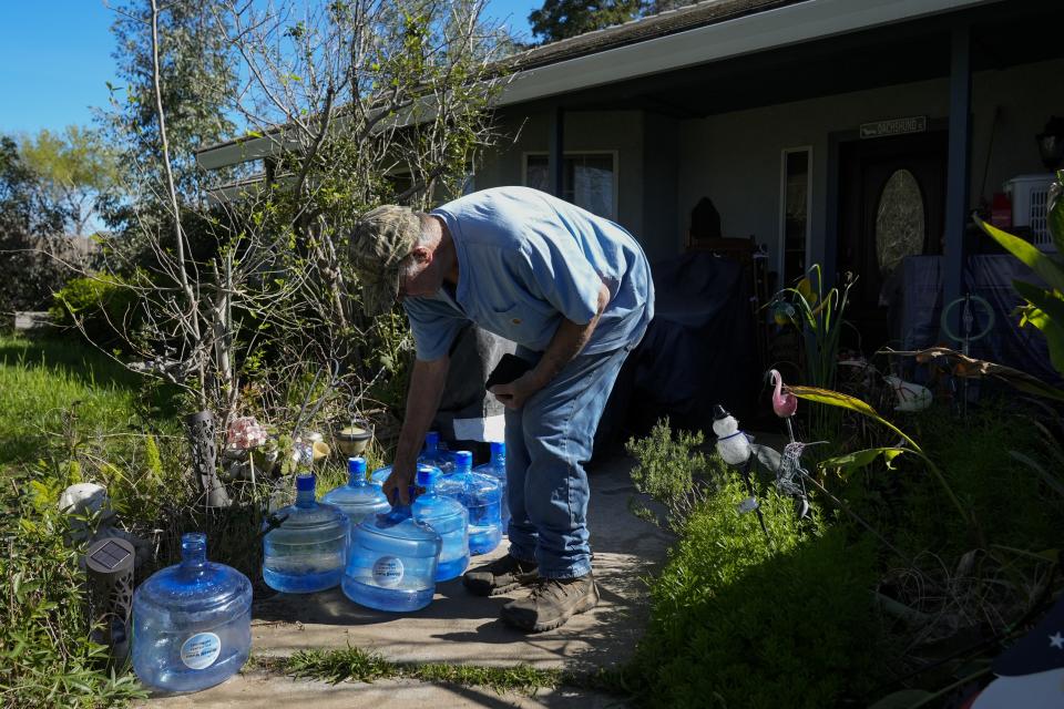 Fred Imfeld and his wife, whose well has dried up, have potable water delivered to their home on Sunday, March 17, 2024, in Corning, Calif. The couple get a 2,500-gallon tank filled with water a few times a month for their needs as they try to save to drill a new well. (AP Photo/Godofredo A. Vásquez)