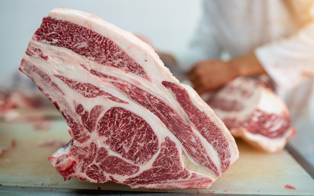 A cut of rib-eye wagyu beef being butchered