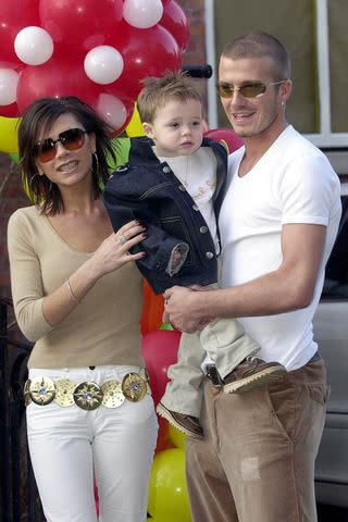 <p>David Jones - PA Images/PA Images via Getty </p> David and Victoria Beckham with their son Brooklyn