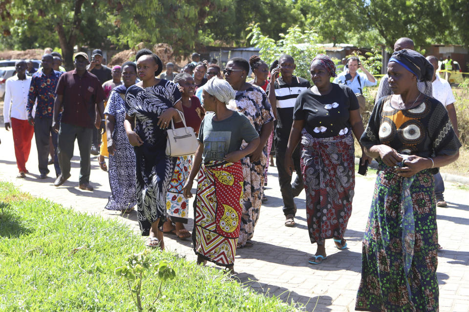 Family member with other relatives wait to receive the bodies of victims of a religious cult for burial in Malindi Funeral home in Kilifi, Kenya Tuesday, March. 26, 2024. Kenya government on Tuesday released seven bodies of victims, who died due to starvation to their families for burial. Some 34 bodies, out of the 429 that were exhumed last year, were positively identified. (AP Photo/Andrew Kasuku)