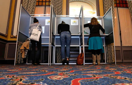 FILE PHOTO: People vote during the Dutch general election, at a polling station opened at Hotel des Indes, in The Hague, Netherlands, March 15, 2017. REUTERS/Yves Herman/File Photo