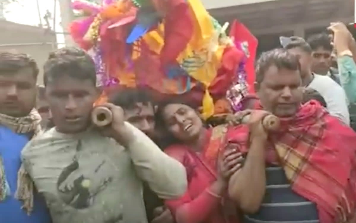 This image from a video shows relatives preparing to cremate the body of a victim suspected to have died after drinking tainted liquor in Saran district of Bihar state, India, Thursday, 15 December 2022 (AP)