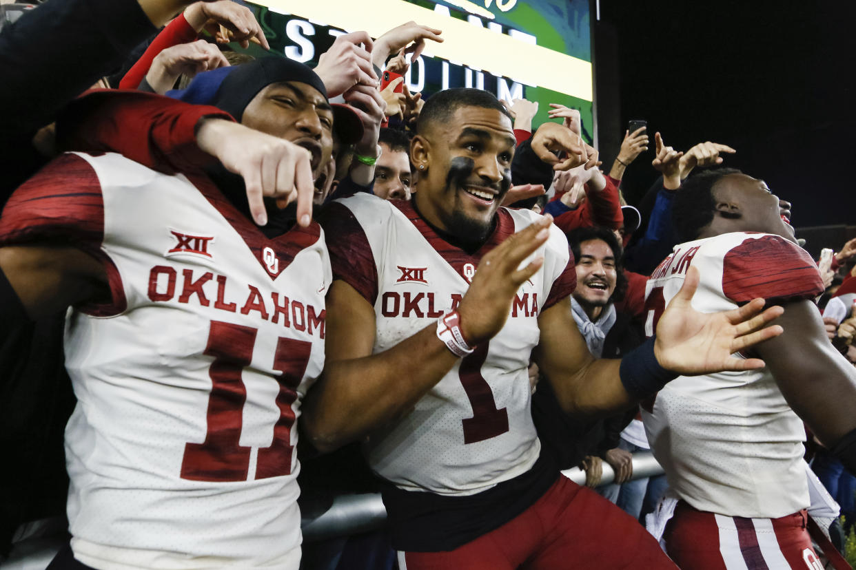 Oklahoma cornerback Parnell Motley (11) and quarterback Jalen Hurts (1) celebrate the 34-31 victory over Baylor following an NCAA college football game in Waco, Texas, Saturday, Nov. 16, 2019. (AP Photo/Ray Carlin)