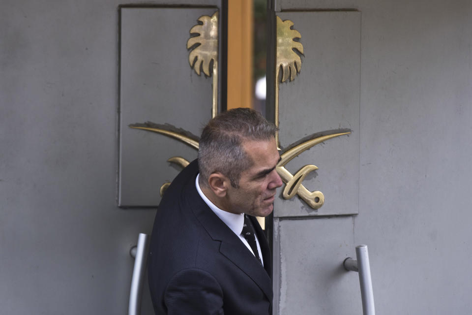 A security guard looks out of the entrance of Saudi Arabia's consulate in Istanbul, Friday, Oct. 12, 2018. A senior Turkish official says Turkey and Saudi Arabia will form a "joint working group" to look into the disappearance of Saudi writer Jamal Khashoggi who vanished last week after entering the Saudi diplomatic mission in Istanbul. (AP Photo/Petros Giannakouris)