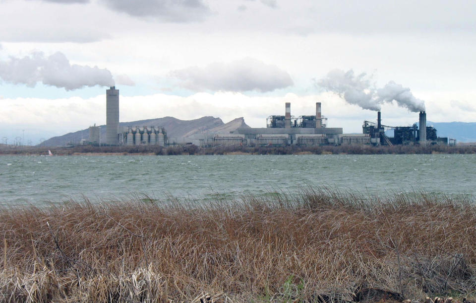 FILE - This April 6, 2006 file photo shows the Four Corners Power Plant, one of two coal-fired plants in northwest New Mexico, near Farmington. Two environmental groups are asking a federal court to set a deadline for the U.S. Environmental Protection Agency to issue mandates for pollution controls at two power plants, including Four Corners, on the Navajo Nation.(AP Photo/Susan Montoya Bryan, File)