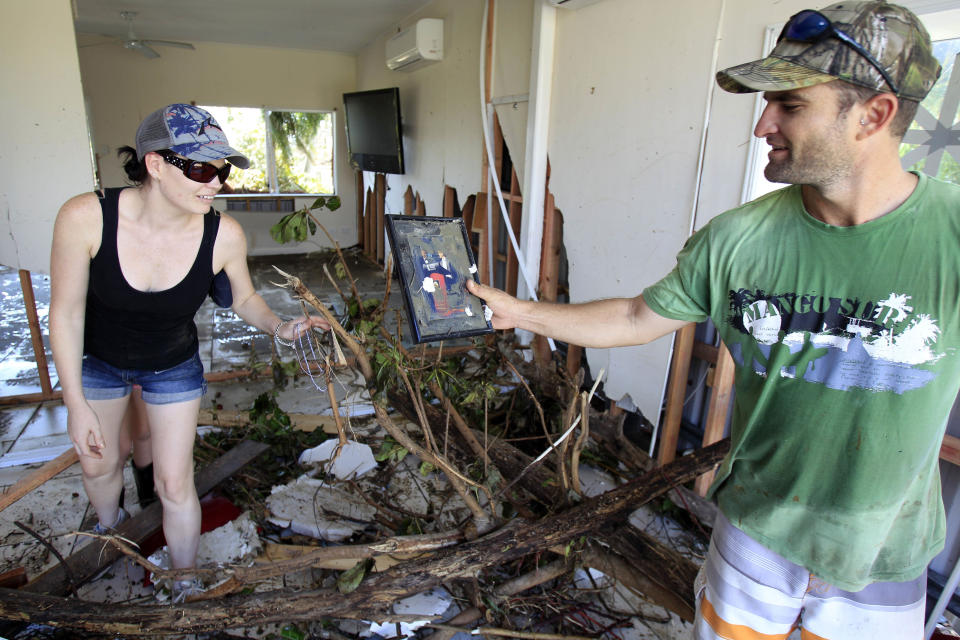 Couple find a photo found in the rubble of their home at Tully Heads, Queensland. Source: AAP