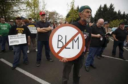 A Sugar Pine Miner supporter holds a anti-BLM sign at a rally outside the Bureau of Land Management's offices in Medford, Oregon April 23, 2015. REUTERS/Jim Urquhart