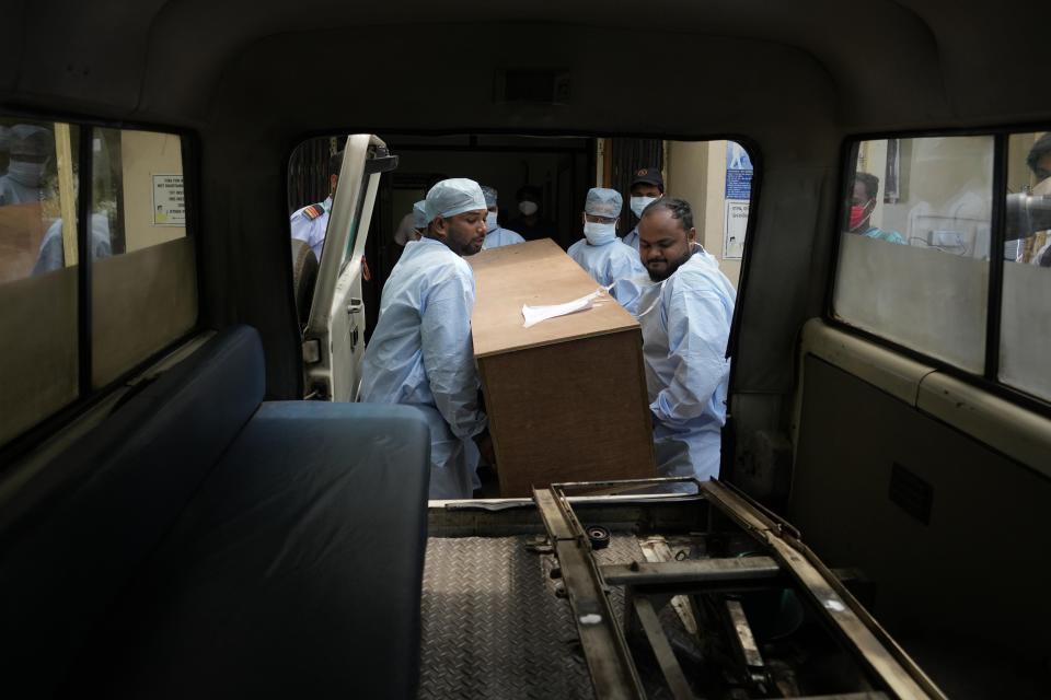 Healthcare workers carry the body of a person who died in Friday's train accident in Balasore, into an ambulance at the All India Institute of Medical Sciences hospital in Bhubaneswar in the eastern state of Orissa, India, Monday, June 5, 2023. Families of the victims of India’s deadliest train crash in decades filled the hospital on Monday to identify and collect bodies of relatives, as railway officials recommended the country’s premier criminal investigating agency to probe the crash that killed 275 people. (AP Photo/Rafiq Maqbool)