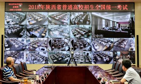 Staff members monitor the venues as students sit for the annual national college entrance examination, or "gaokao", in Xian, Shaanxi province, China June 7, 2018. Wang Jian/Xi'an Evening News via REUTERS