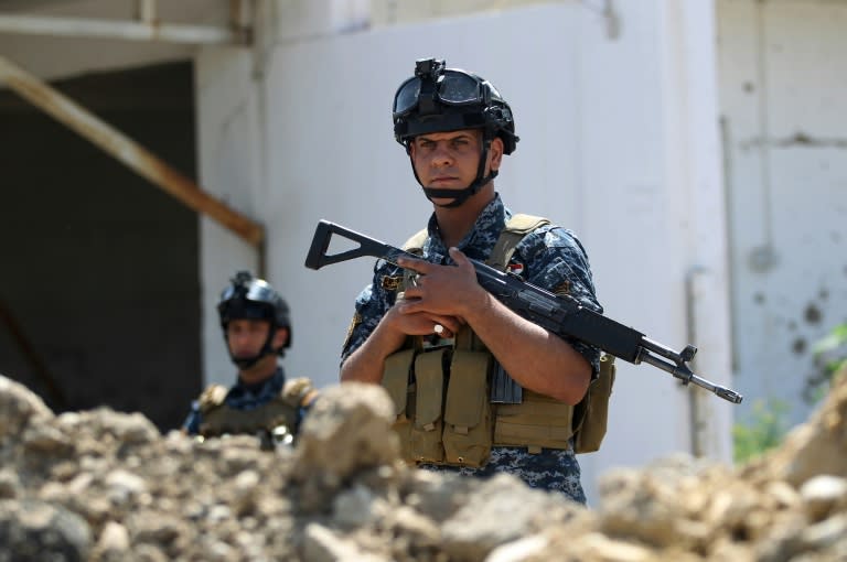 Iraqi security personnel hold a position on the front line in Mosul's Old City on May 3, 2017