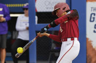 Florida State's Kalei Harding singles against Washington during the first inning of an NCAA softball Women's College World Series game Saturday, June 3, 2023, in Oklahoma City. (AP Photo/Nate Billings)