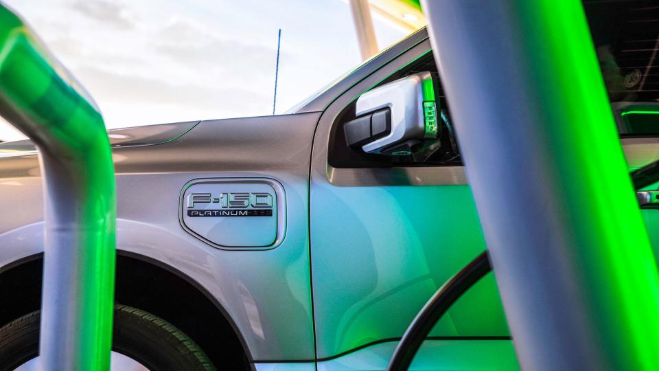 Ford F-150 Lightning pickup at a charging station.