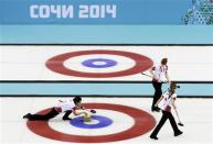 Canada's second Jill Officer (L) delivers a stone as lead Dawn McEwen (top R) and vice Kaitlyn Lawes prepare to sweep in their women's gold medal curling game against Sweden at the Ice Cube Curling Centre during the Sochi 2014 Winter Olympics February 20, 2014. REUTERS/Ints Kalnins