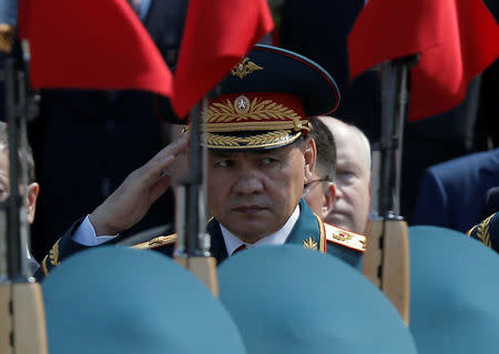 FILE PHOTO: Russian Defence Minister Sergei Shoigu watches honor guards passing by during a wreath-laying ceremony to mark the 71st anniversary of the victory over Nazi Germany in World War Two, at the Tomb of the Unknown Soldier by the Kremlin walls in Moscow, Russia May 9, 2016. REUTERS/Maxim Shemetov/File Photo