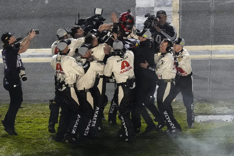 William Byron, wearing helmet, celebrates with the crew after winning the NASCAR Daytona 500 auto race Monday, Feb. 19, 2024, at Daytona International Speedway in Daytona Beach, Fla. (AP Photo/Chris O'Meara)