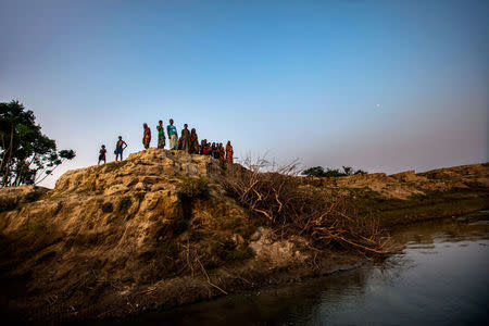 Villagers gather along an eroded river bank in the Jamalpur district of Northern Bangladesh April 19, 2016. Thomson Reuters Foundation/Saiful Huq Omi