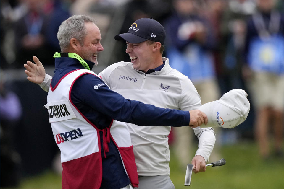 Matthew Fitzpatrick, of England, celebrates with his caddie after winning the U.S. Open golf tournament at The Country Club, Sunday, June 19, 2022, in Brookline, Mass. (AP Photo/Robert F. Bukaty)