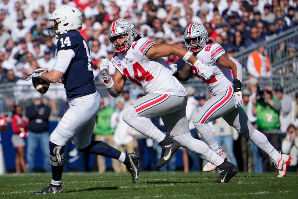 Ohio State Buckeyes defensive end J.T. Tuimoloau pursues Penn State Nittany Lions quarterback Sean Clifford during the first half of the NCAA Division I football game at Beaver Stadium.