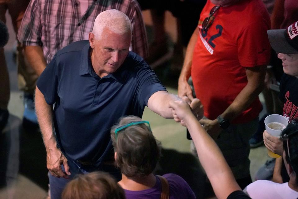 Republican presidential candidate and former Vice President Mike Pence stops to greet fairgoers while touring the grounds at the Iowa State Fair, Friday, Aug. 11, 2023, in Des Moines, Iowa.