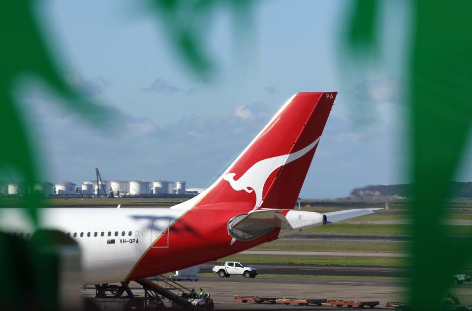 A file picture shows the tail part of a Qantas Airways aircraft seen through a decorative window from the international terminal at Sydney Airport.