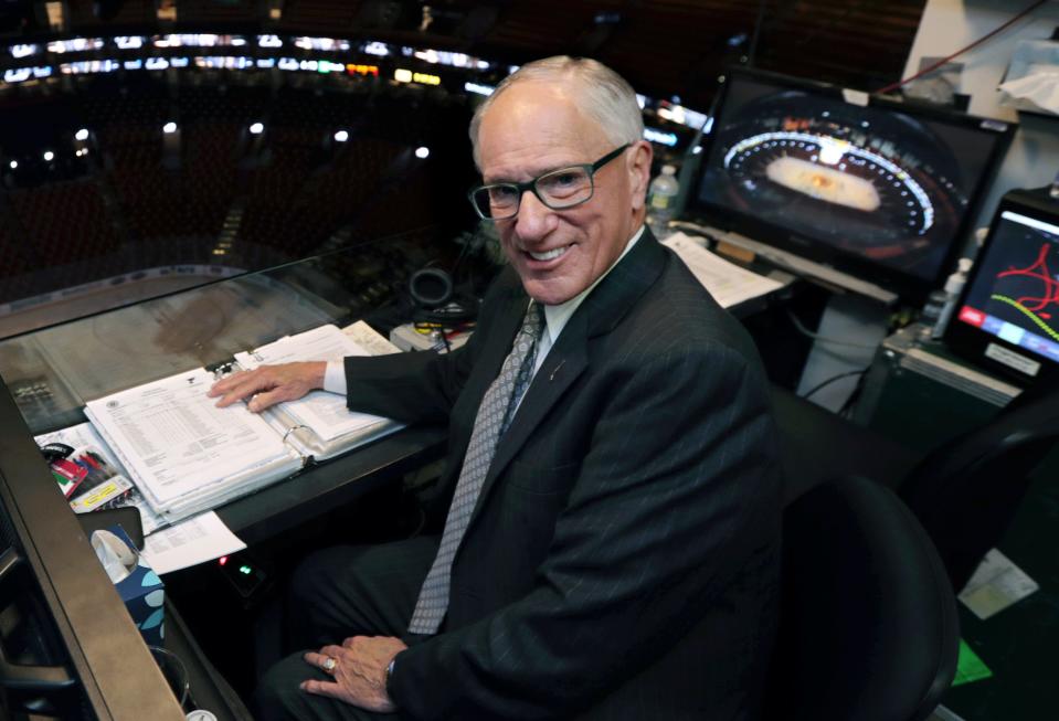 In this May 29, 2019, photo, NBC hockey broadcaster Mike Emrick poses for a photo while preparing to call Game 2 of the NHL hockey Stanley Cup Final between the St. Louis Blues and the Boston Bruins in Boston.