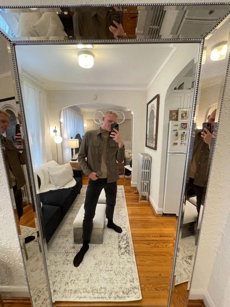 The writer taking a selfie in a large glass mirror